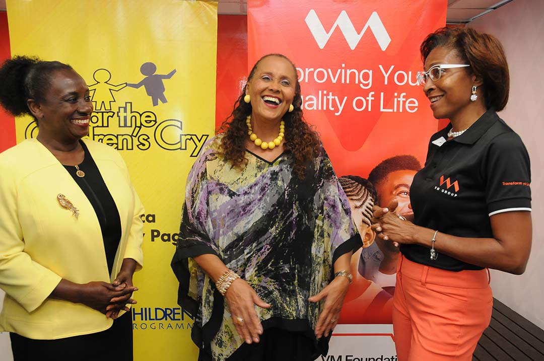 (From left) Maureen Thompson, Director General for the Jamaica Library Service and Betty Ann Blaine, Founder of Hear the Children’s Cry, are both smiling from ear to ear as they share a light moment with VM Foundation CEO, Samantha Charles, at a recent handover ceremony at VM’s Corporate Offices in Kingston.