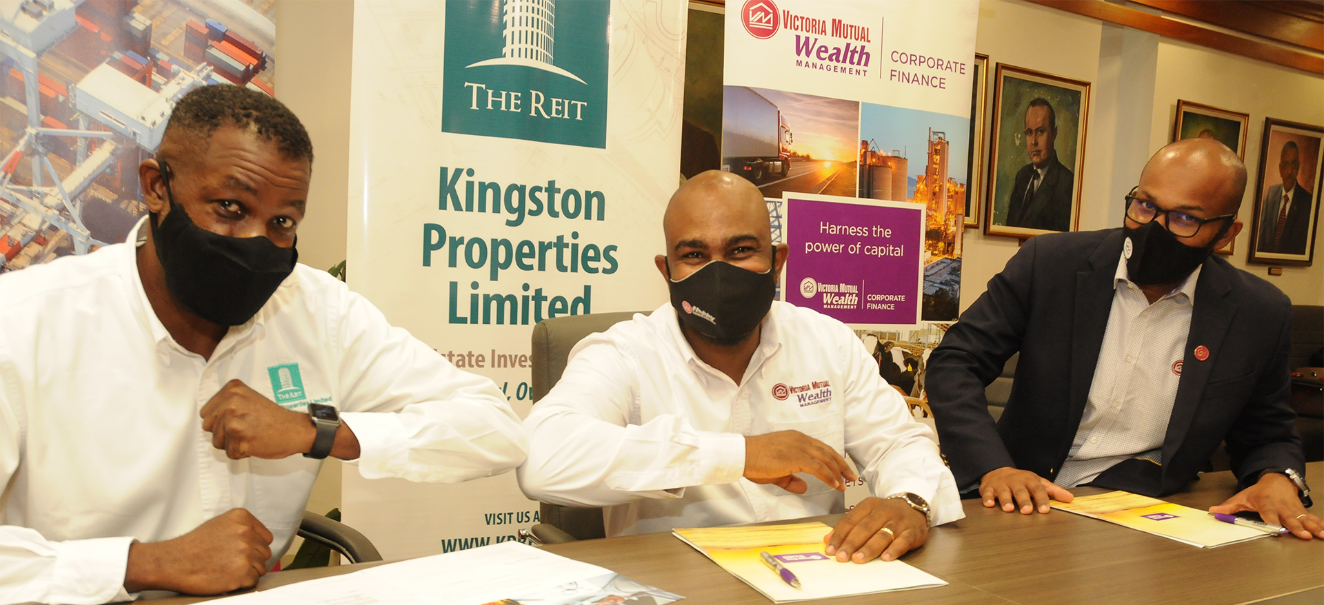 Dwight Jackson (centre), Assistant Vice President, Corporate Finance, Victoria Mutual Wealth Management Ltd., shares a moment with Kevin Richards (left), CEO, Kingston Properties Limited, during a signing ceremony at the Victoria Mutual corporate offices on Friday (May 28). Looking on (at right) is Rezworth Burchenson, CEO, Victoria Mutual Investments Limited (VMIL) & VM Wealth. The ceremony was used to commemorate the completion of a $700 million bridge loan deal between VMIL and Kingston Properties.