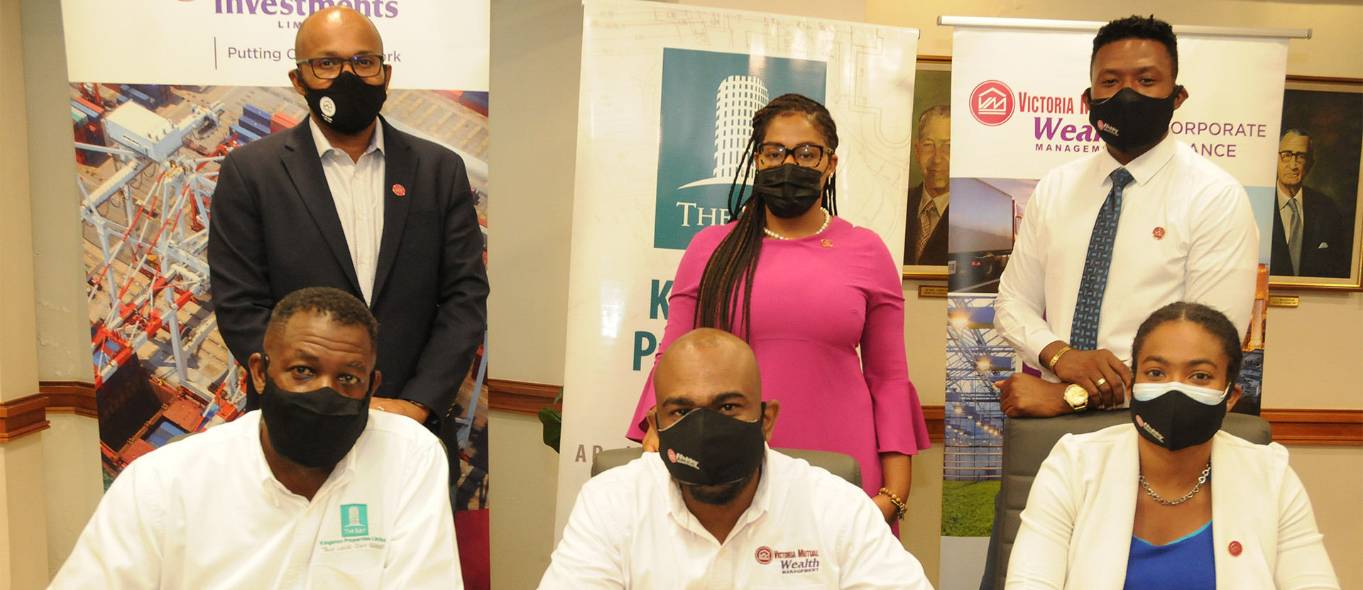 (From left, seated) Kevin Richards (left), CEO, Kingston Properties Limited; Dwight Jackson, Assistant Vice President, Corporate Finance, Victoria Mutual Wealth Management Ltd.; and Karla Brown, Acting Assistant Manager, Capital Markets, is joined by Rezworth Burchenson (standing, from left), CEO, Victoria Mutual Investment Limited (VMIL) & VM Wealth; Roxanne Christian-White, Assistant Manager, Corporate Finance; and Jovaughn Vanriel, Corporate Finance Officer, following a signing ceremony at the Victoria Mutual corporate offices on Friday (May 28), to ink a $700 million bridge loan deal between VMIL and Kingston Properties.