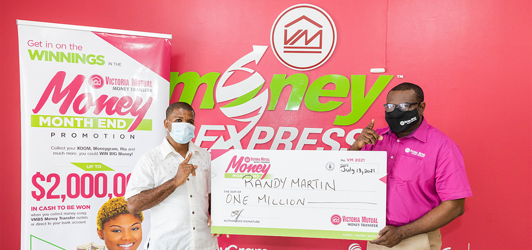 Randy Martin: Michael Howard (right), CEO, VM Money Transfer Services (VMTS), presents Randy Martin, grand prize winner of the VMTS Month End promotion with a cheque of $1 million dollars, at the VM Money Express Shop in Savanna-la-Mar, on July 13, 2021.