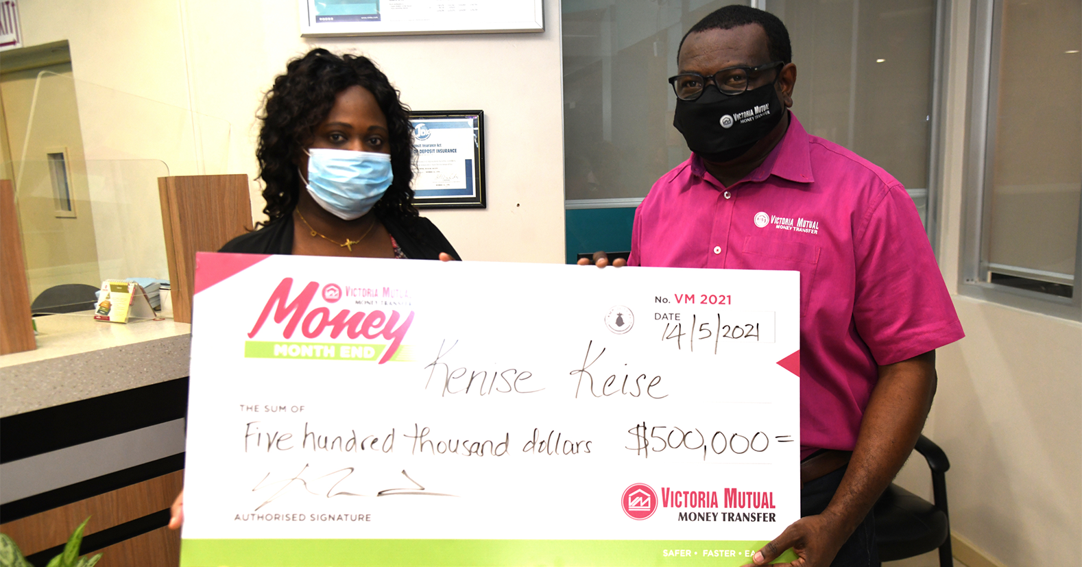 Kenise Keise: Michael Howard (right), CEO, VM Money Transfer Services (VMTS), presents Kenise Keise, 2nd place winner in the VMTS Month End promotion, with a cheque of $500,000, at the VMTS location inside the VMBS Ocho Rios Branch.
